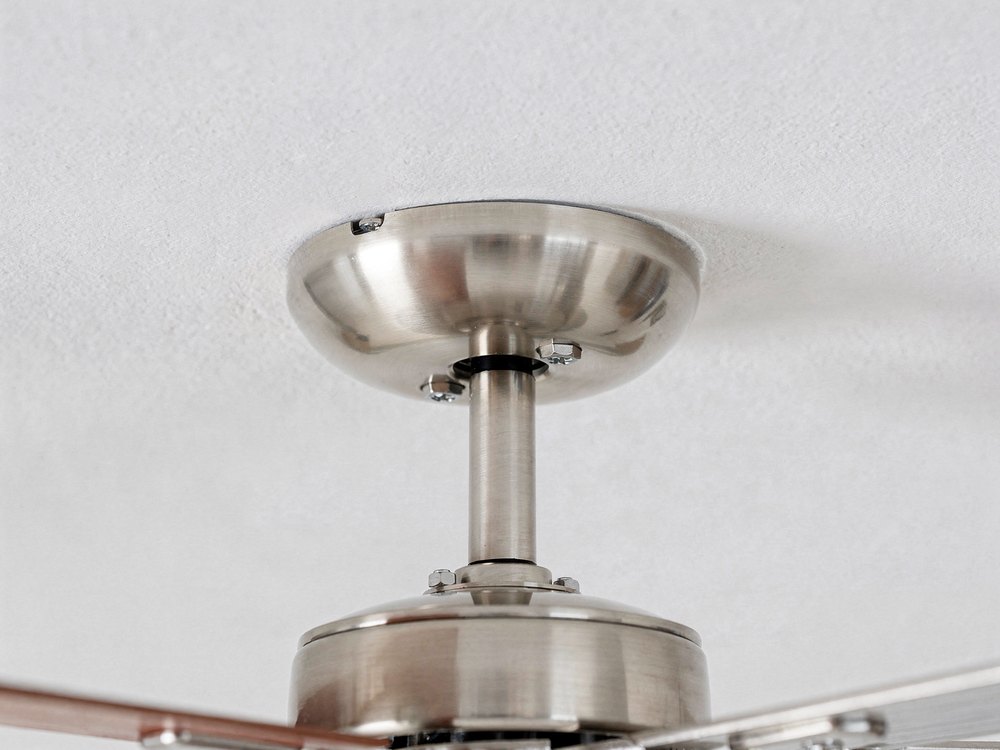 Electrician installing a ceiling fan in a Houston, TX home